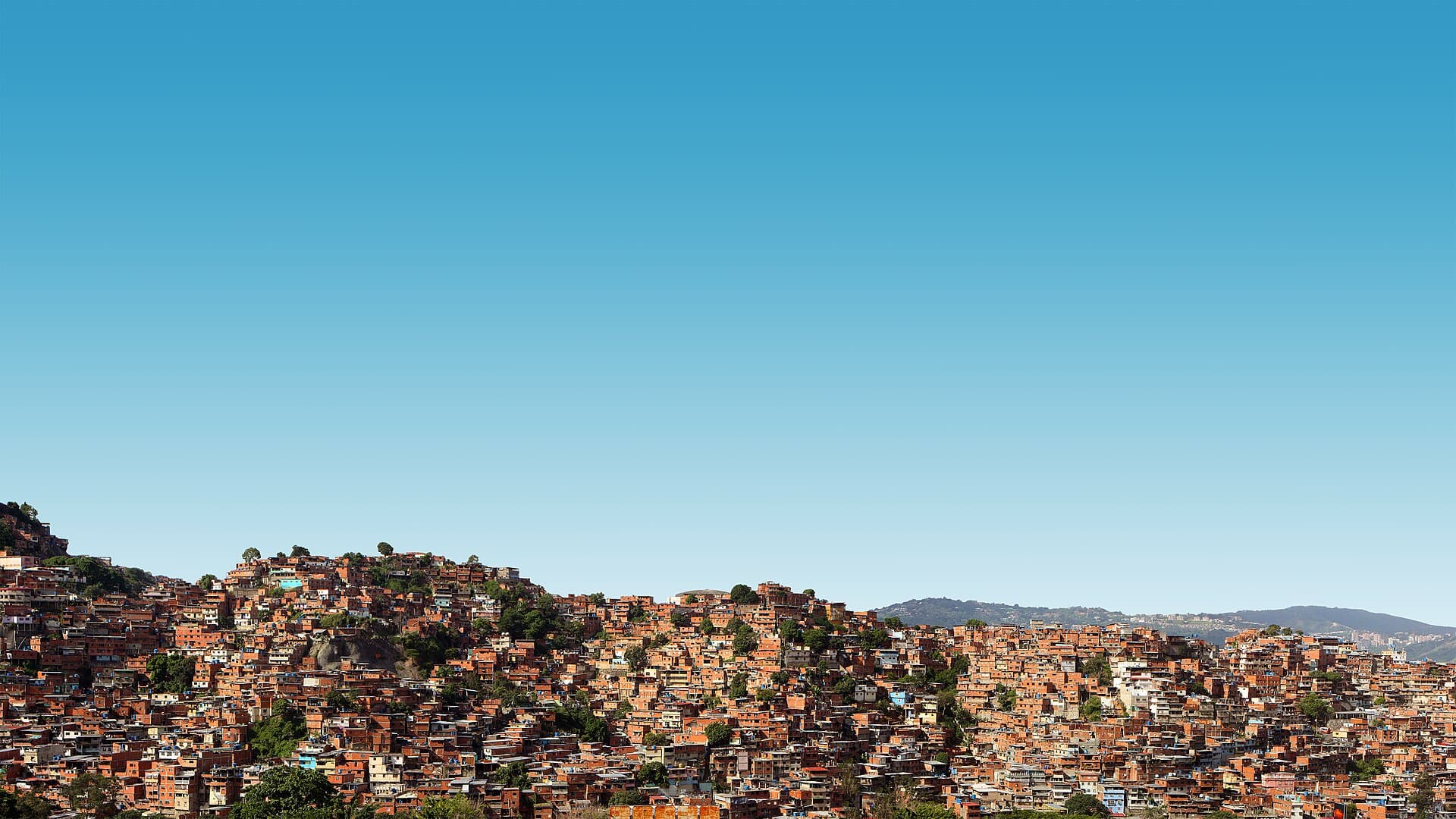 Houses on the hills of Petare under a clear sky