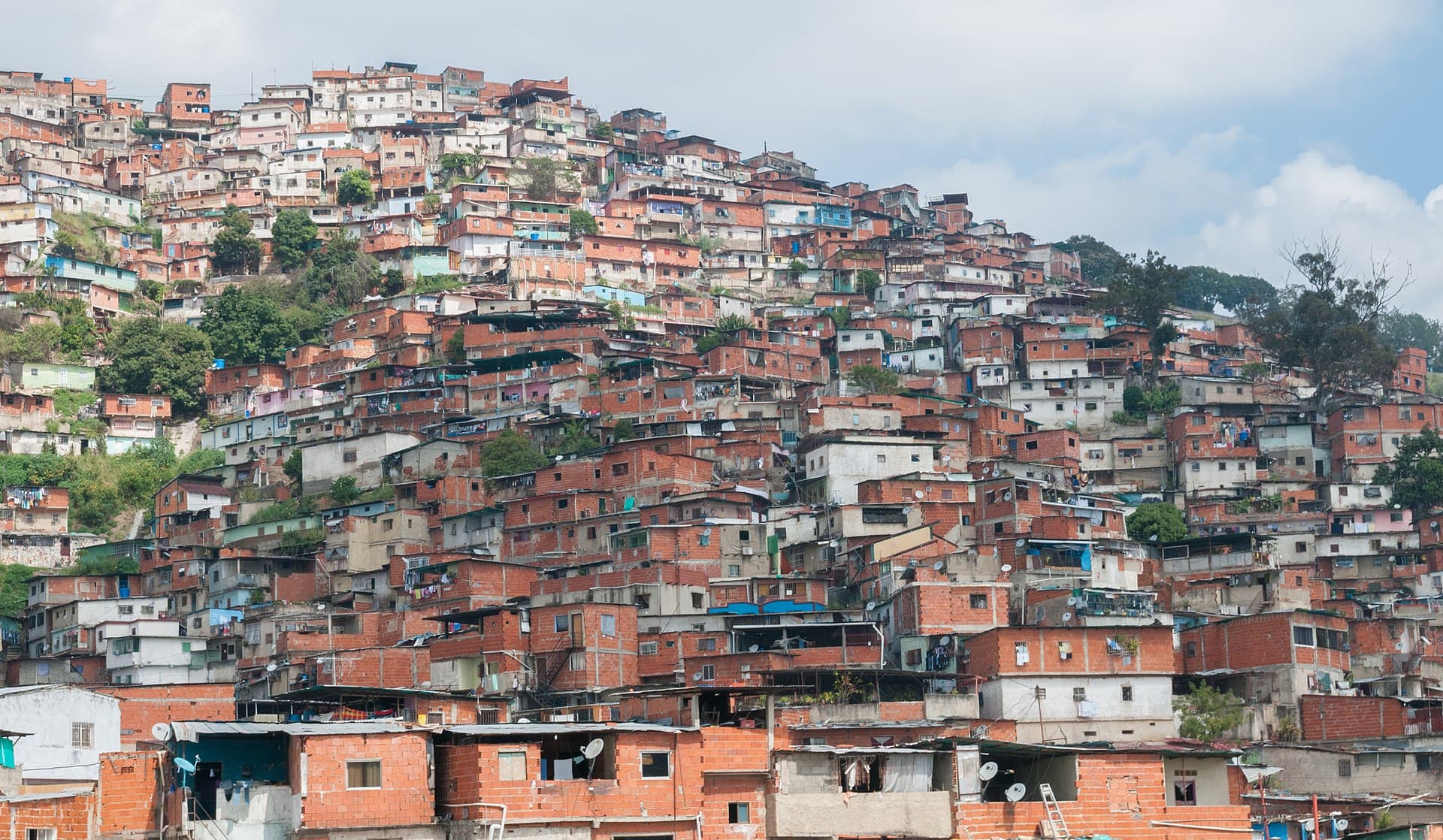 Brick houses packed up a hillside in Petare, Caracas